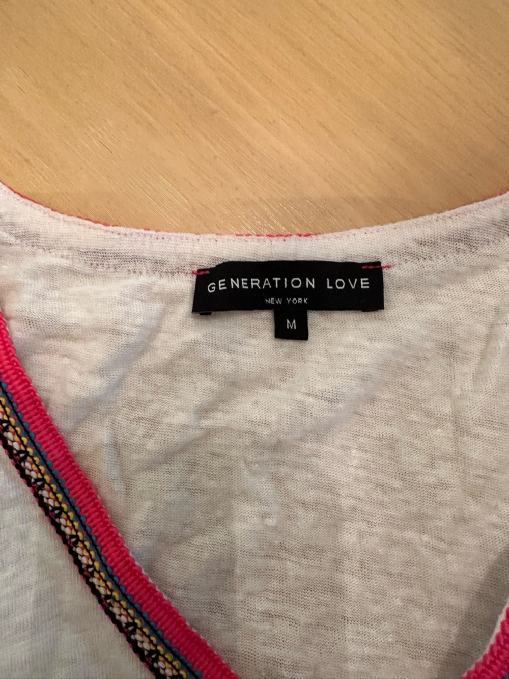 Generation Love v neck white tank with embroidered ribbon at neck and sides